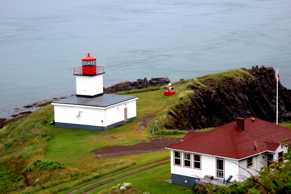 The Cape d'Or lighthouse overlooks the Bay of Fundy with staggering steep cliffs.  A gorgeous spot in Nova Scotia.