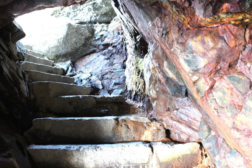 The final steps into one of the sea caves.  Notice the bright colours in the rocks in the wall.  Awesome place for an adventure.