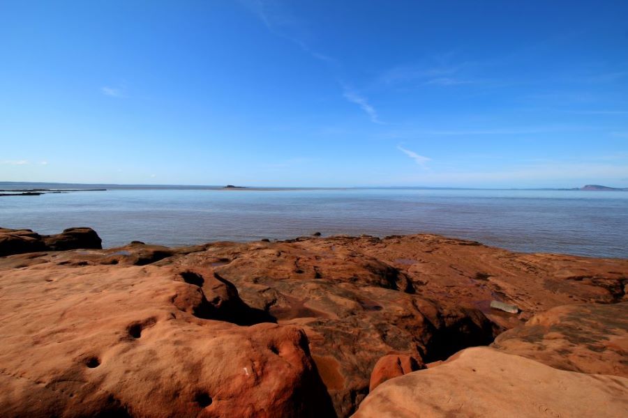 A view of the Bay of Fundy from the coastline along the Thomas Cove hiking trail.  The red sandstone rocks where you can roam at low tide are magnificent.
